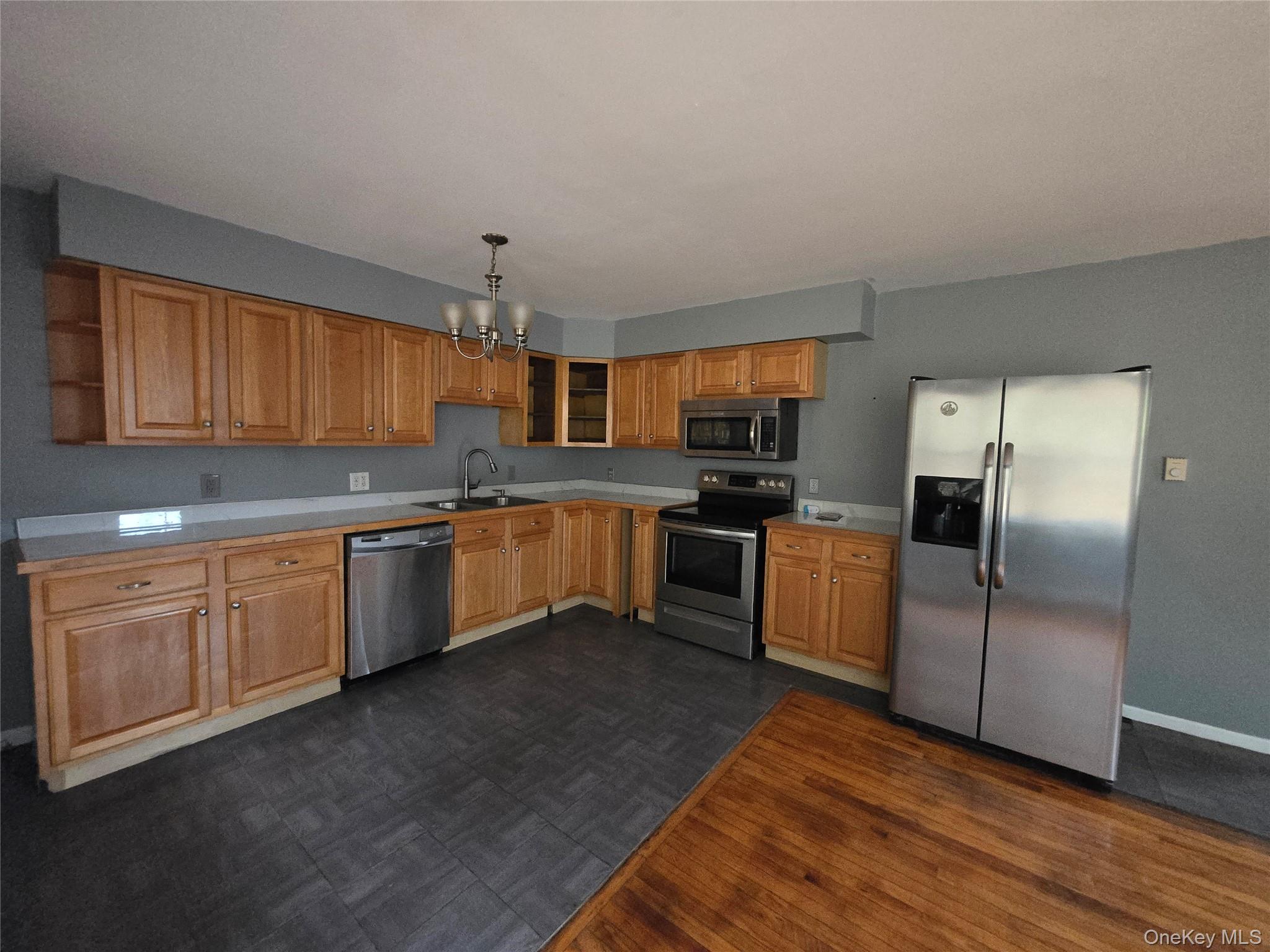 43 Glenmere Homesites Road Florida, NY 10921 - Photo 5 of 30 Kitchen with appliances with stainless steel finishes, a chandelier, light countertops, and decorative light fixtures