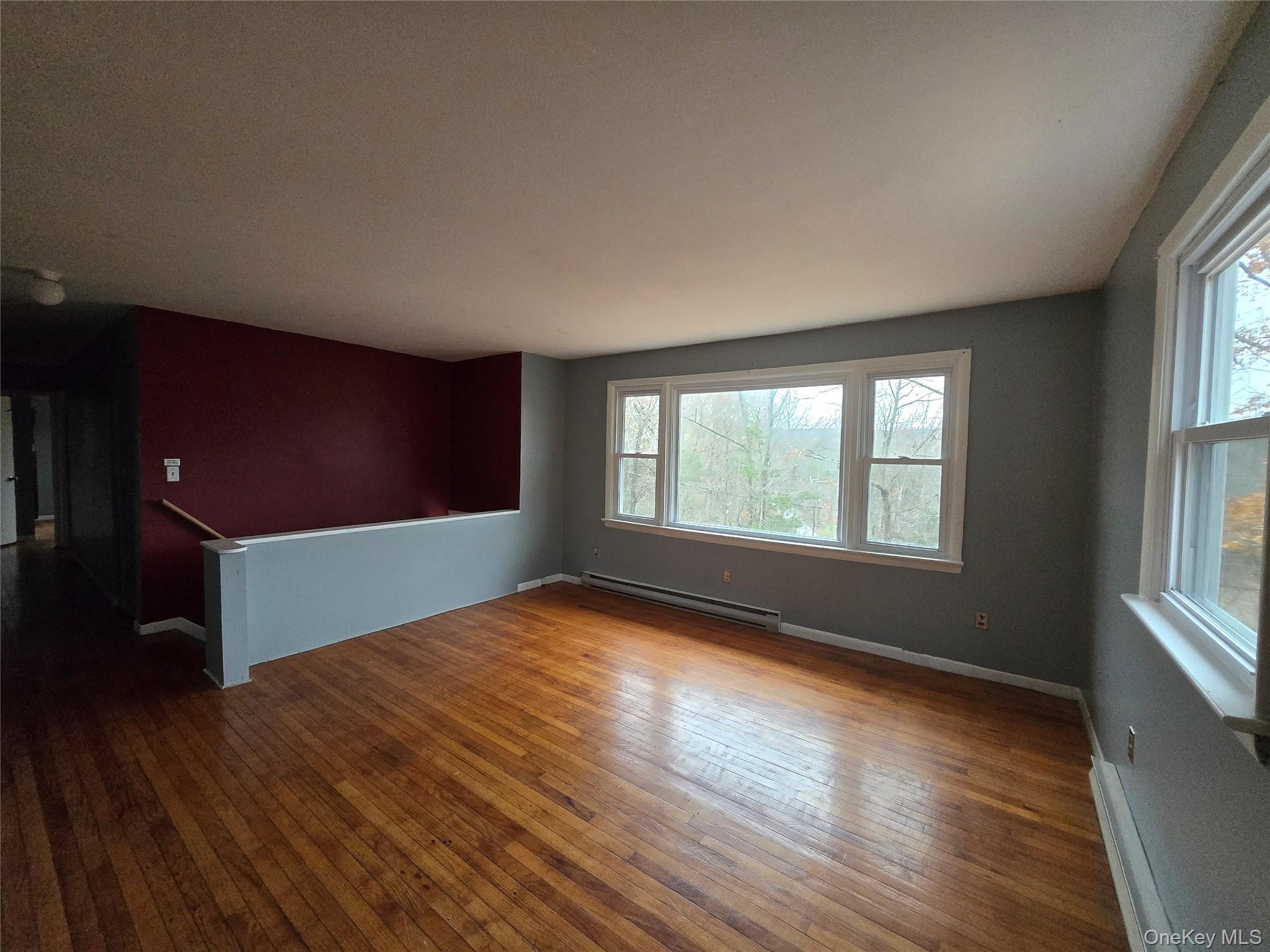 43 Glenmere Homesites Road Florida, NY 10921 - Photo 8 of 30 Empty room with hardwood / wood-style floors and a baseboard heating unit