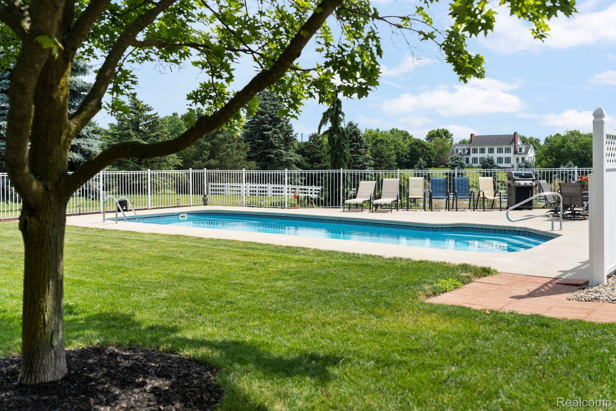 3310 Middle Road Highland, MI 48357 - Photo 32 of 45 Fenced in pool area and lawn