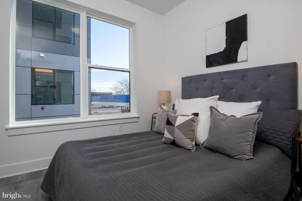 a bed sitting in a bedroom next to a window