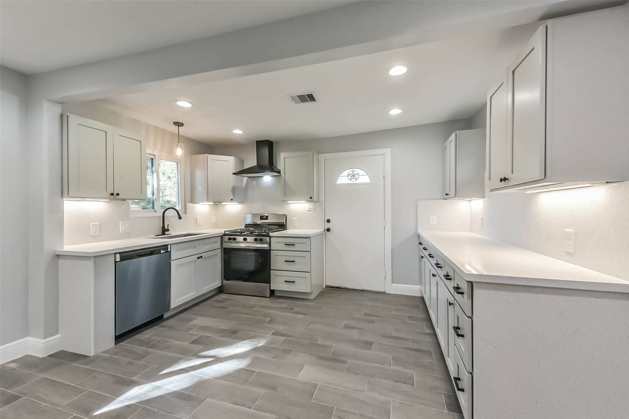 8925 Everglade Drive Houston, TX 77078 - Photo 11 of 31 a kitchen with granite countertop a sink and white cabinets