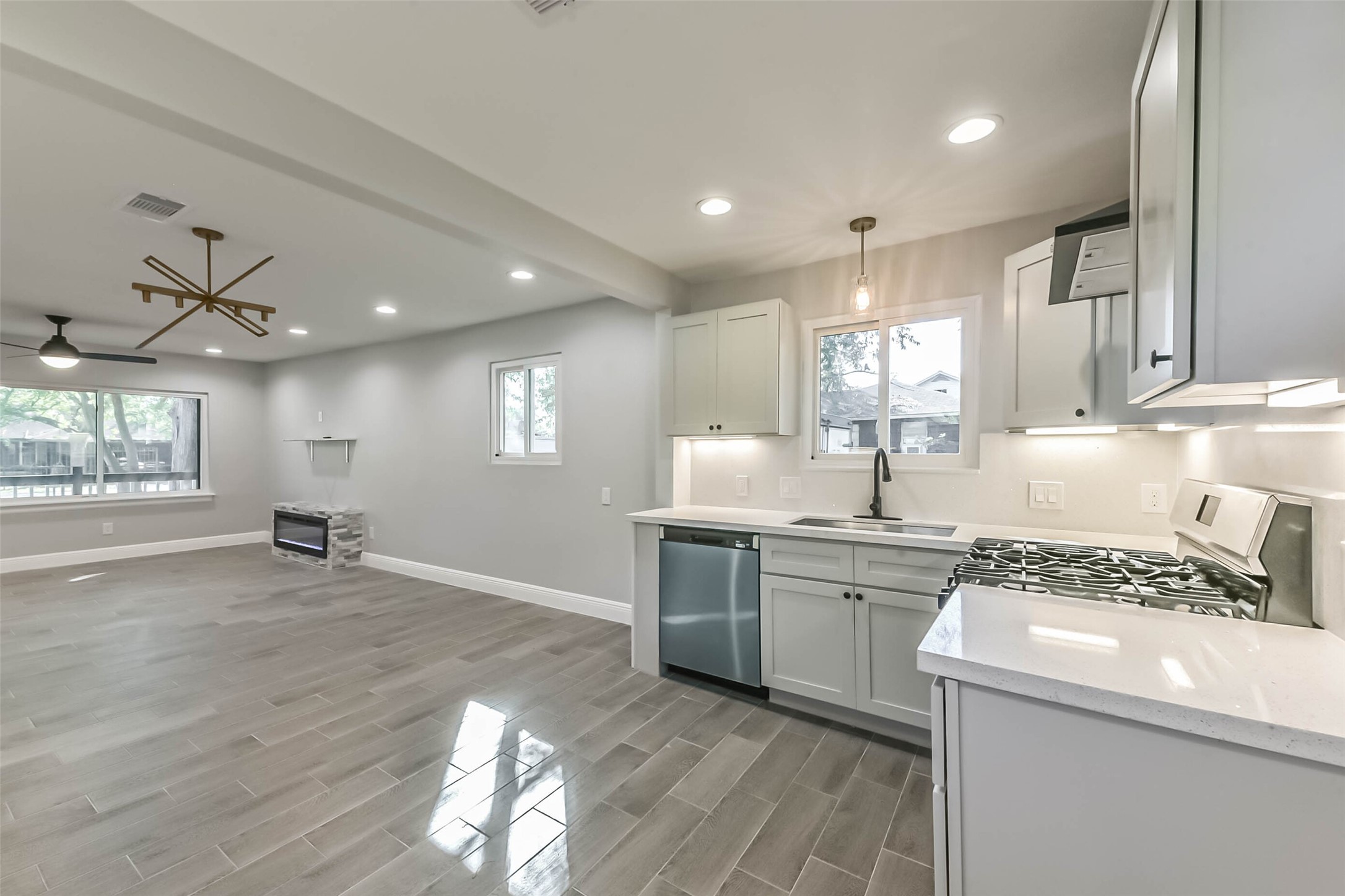 8925 Everglade Drive Houston, TX 77078 - Photo 15 of 31 a kitchen with a stove a sink and wooden floor