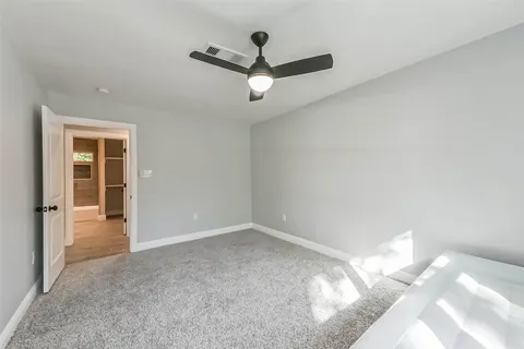 a view of a livingroom with a ceiling fan and window