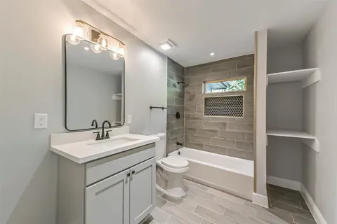 a bathroom with a sink a toilet and mirror