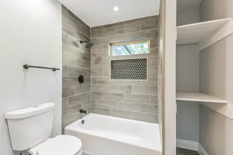 a bathroom with a toilet and a bathtub