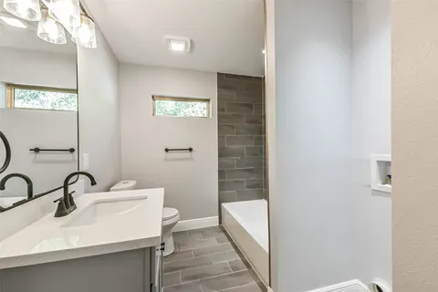 a bath tub sitting next to a bathroom sink