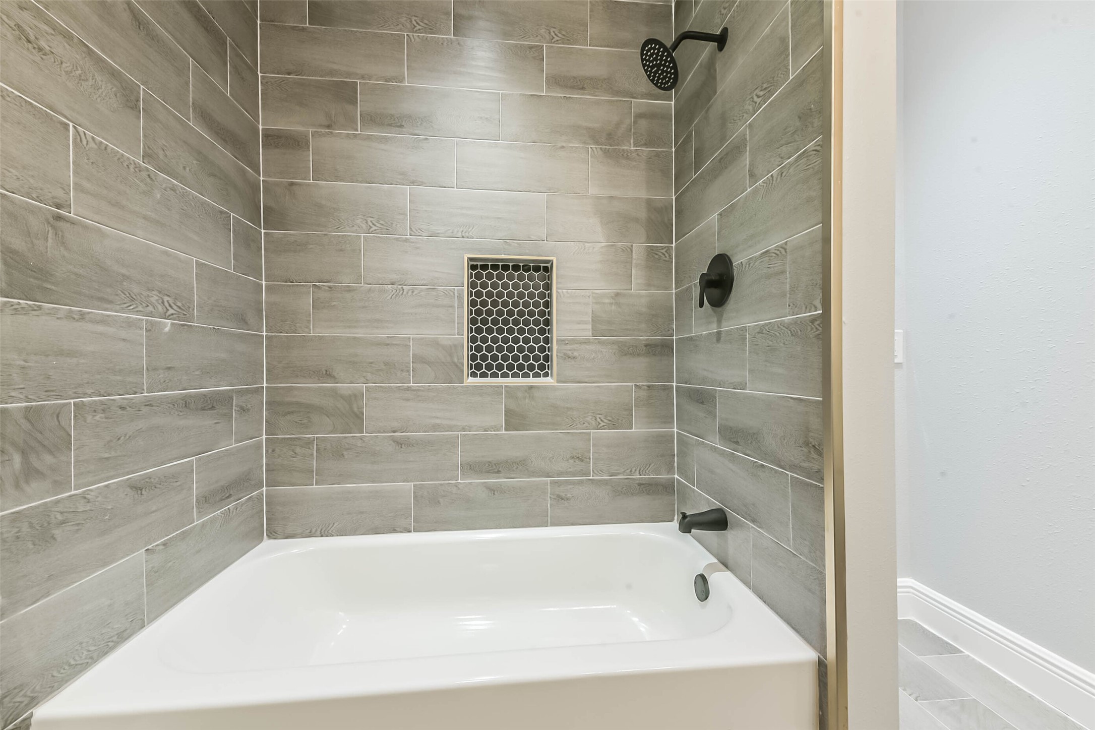 8925 Everglade Drive Houston, TX 77078 - Photo 27 of 31 a bath tub sitting next to a bathroom sink