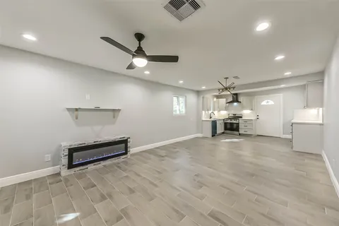 an empty room with a empty space and wooden floor
