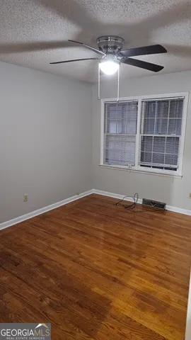 a view of a room with wooden floor and cabinet