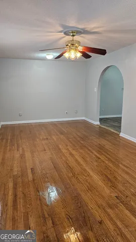 a view of empty room with wooden floor