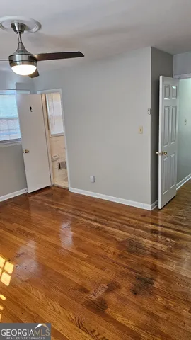 a view of a room with wooden floor and staircase