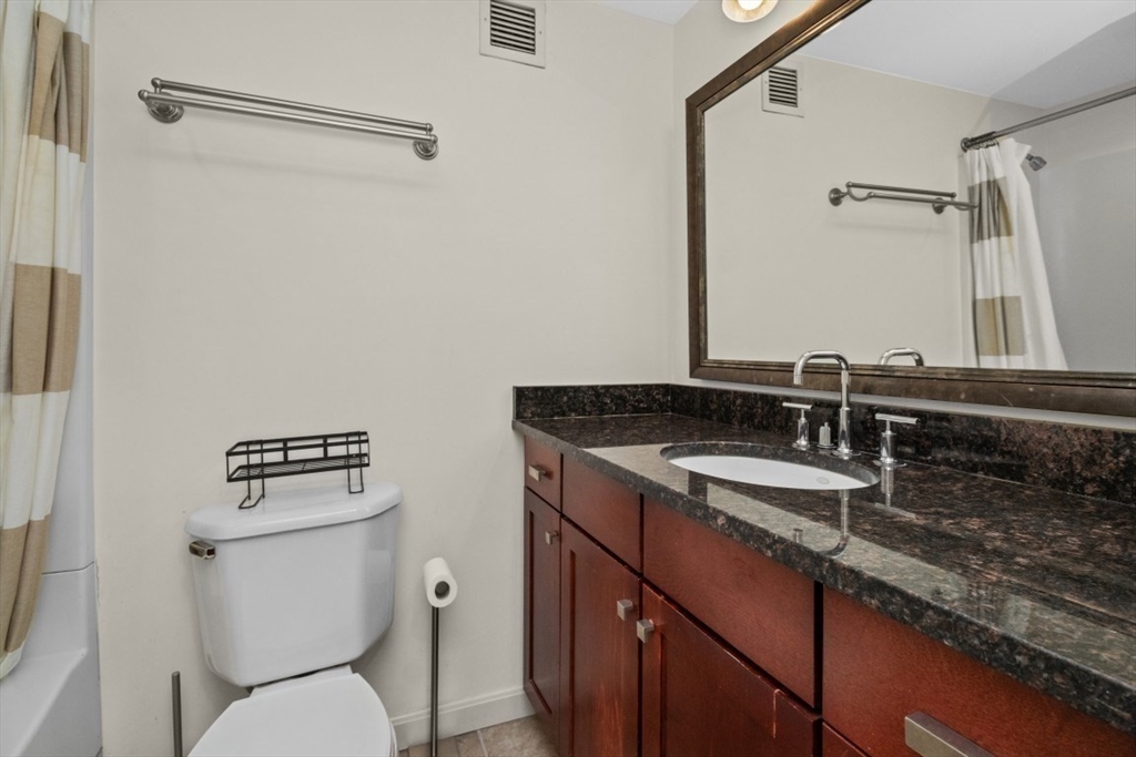 10 Museum Way, Unit 1322 Cambridge, MA 02141 - Photo 10 of 30 a bathroom with a granite countertop sink toilet and mirror