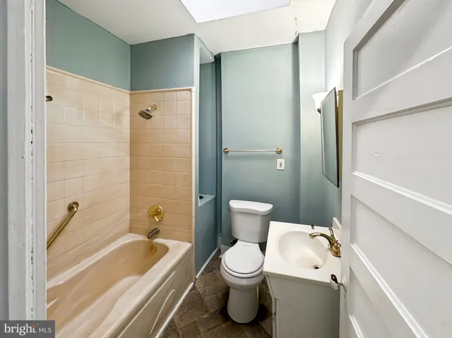 a bathroom with a toilet a sink and bathtub