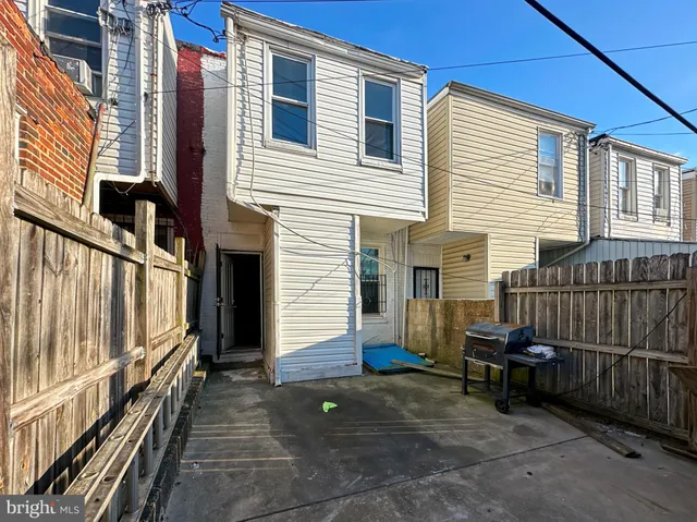 a view of a house with wooden fence