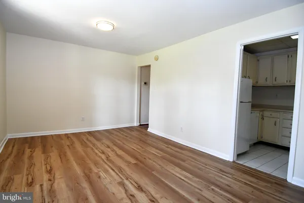 a view of an empty room with closet and a window