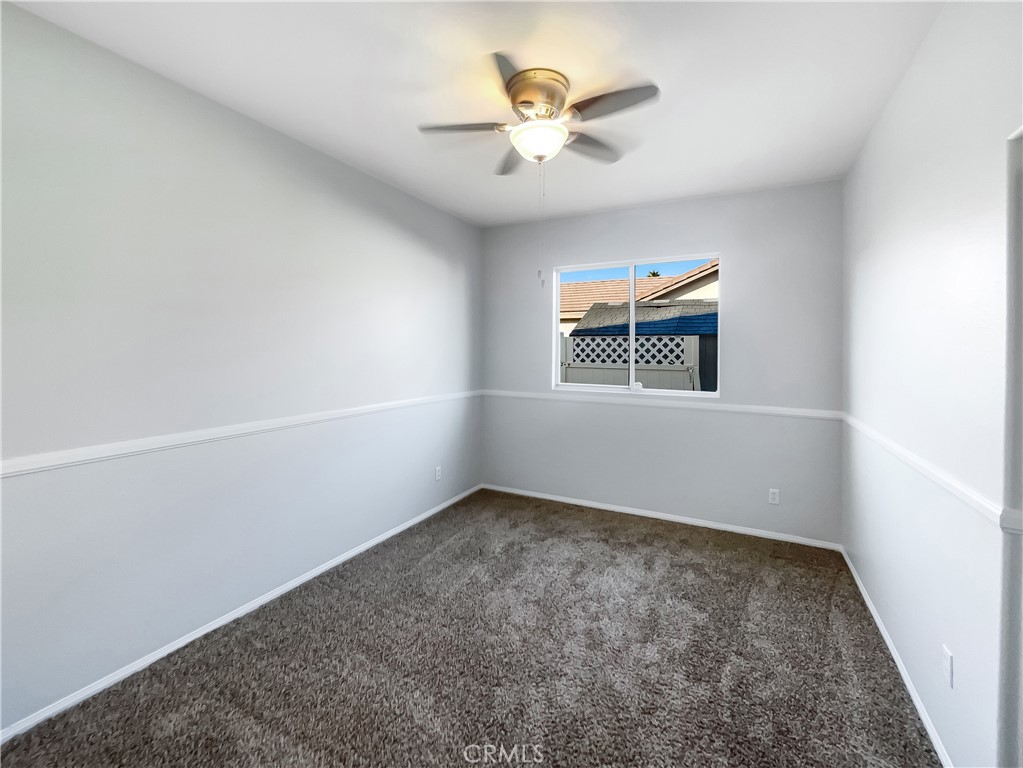 3429 Catalina Avenue Hemet, CA 92545 - Photo 12 of 20 an empty room with windows and fan