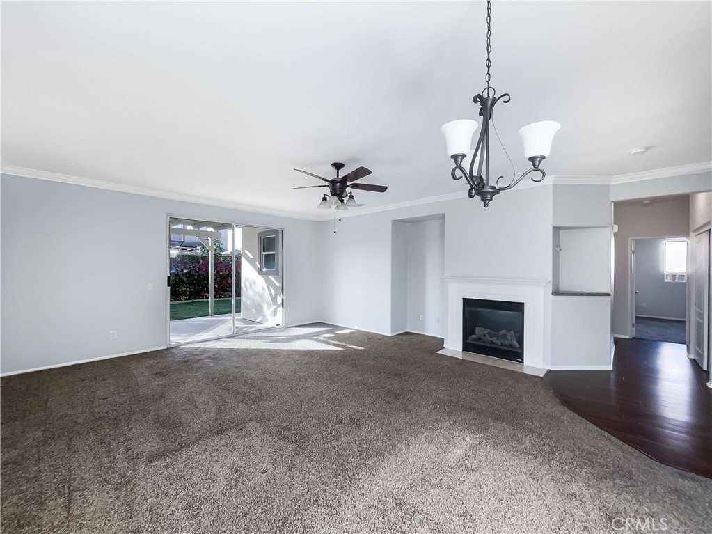 3429 Catalina Avenue Hemet, CA 92545 - Photo 3 of 20 a view of empty room with wooden floor and fireplace