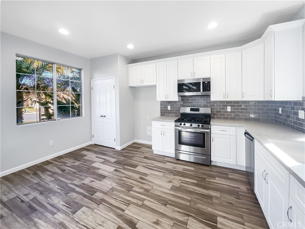 3429 Catalina Avenue Hemet, CA 92545 - Photo 7 of 20 a kitchen with granite countertop a stove a sink and a refrigerator
