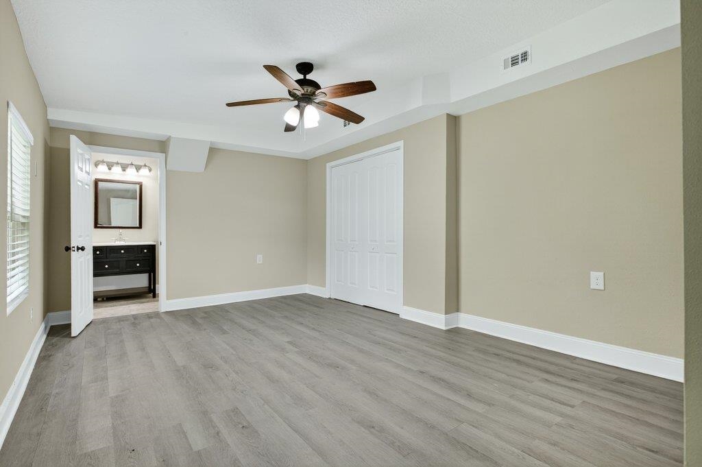 125 Menendez Road St. Augustine, FL 32080 - Photo 17 of 41 an empty room with wooden floor closet and windows