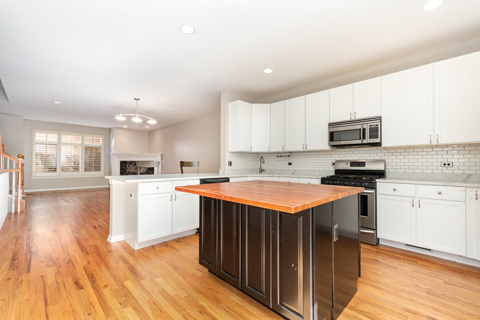 1022 Alexander Lane Oak Park, IL 60302 - Photo 10 of 19 a kitchen with stainless steel appliances granite countertop a stove top oven a sink dishwasher and a microwave oven with wooden floor