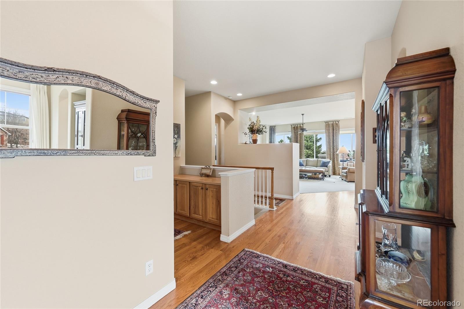 2626 Pemberly Avenue Highlands Ranch, CO 80126 - Photo 13 of 49 a view of a hallway with wooden floor and furniture