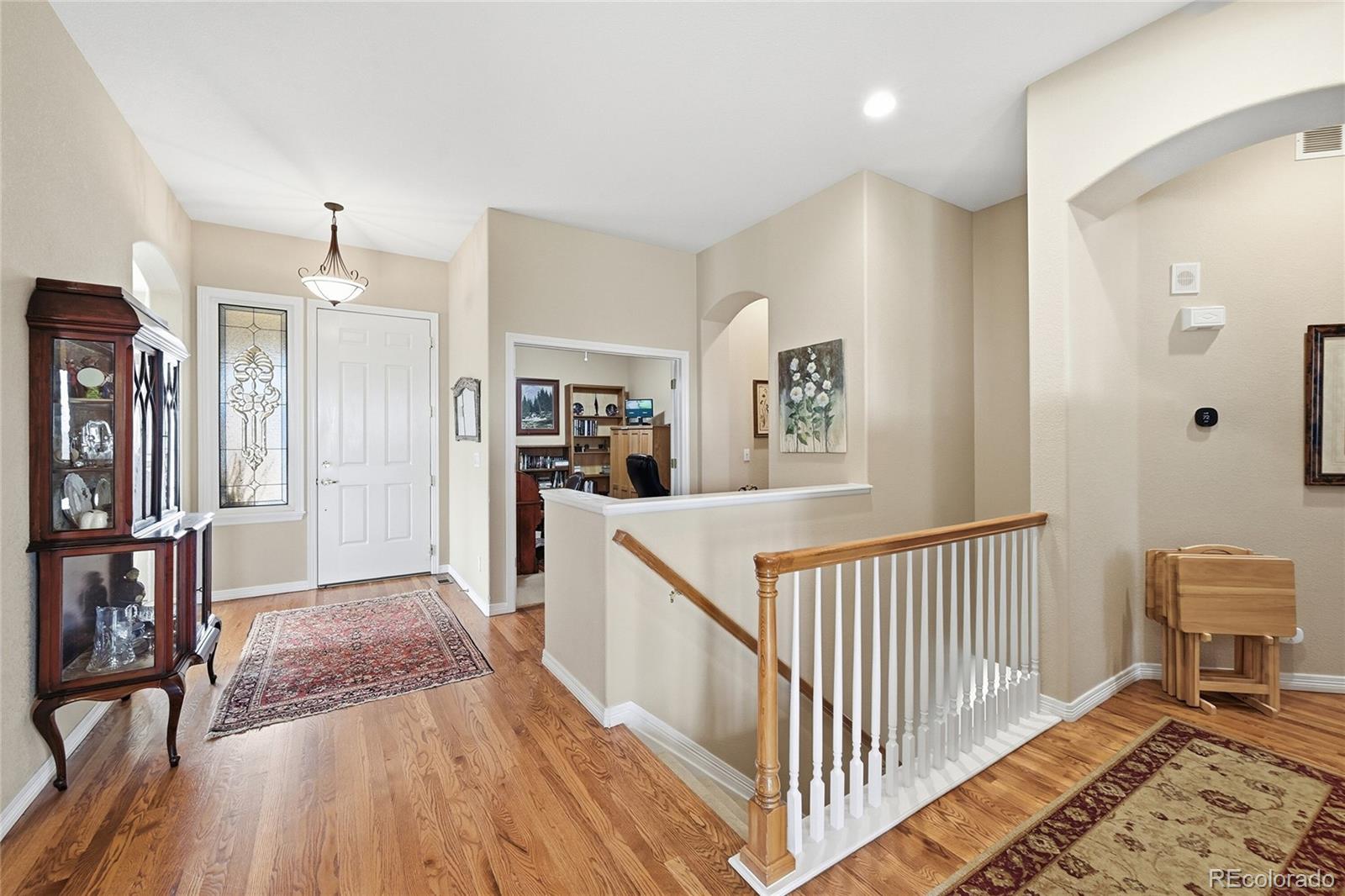 2626 Pemberly Avenue Highlands Ranch, CO 80126 - Photo 14 of 49 a view of a hallway with wooden floor and windows