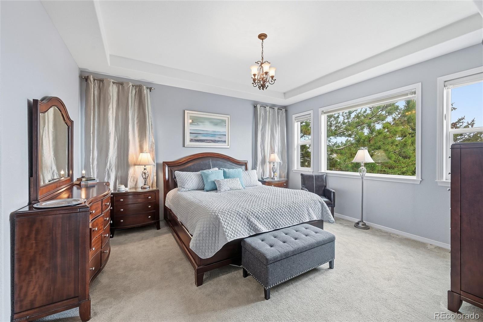 2626 Pemberly Avenue Highlands Ranch, CO 80126 - Photo 18 of 49 a spacious bedroom with a bed a window and dresser