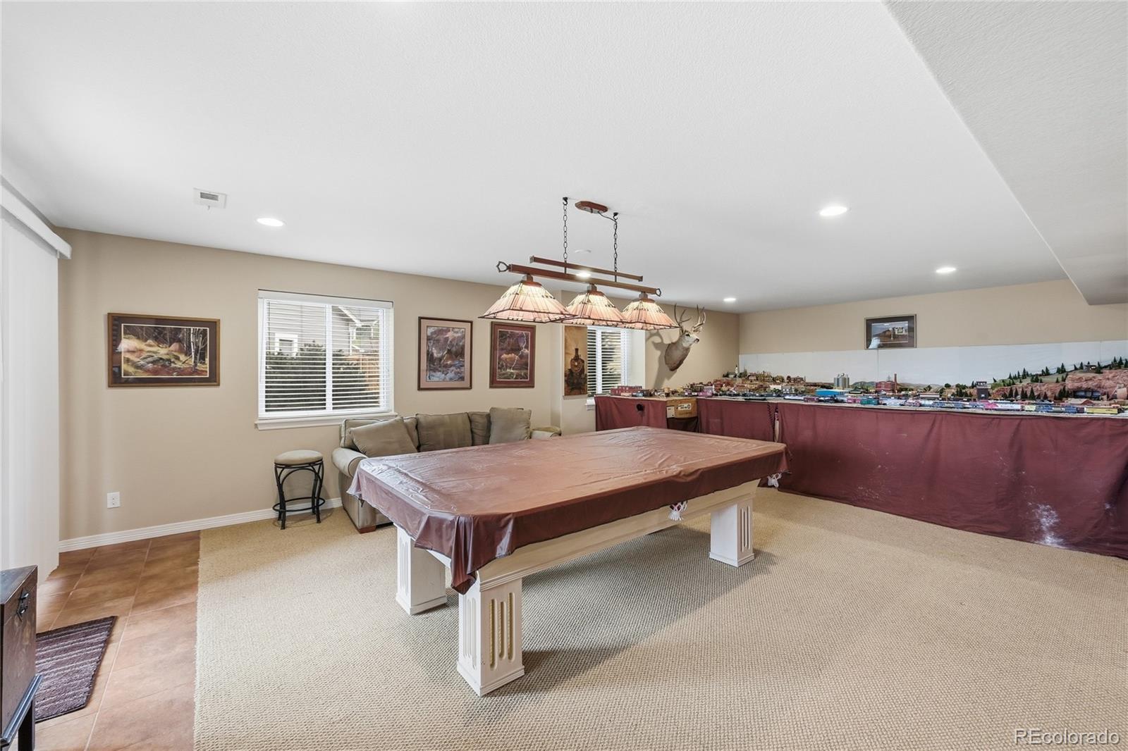 2626 Pemberly Avenue Highlands Ranch, CO 80126 - Photo 28 of 49 a living room with furniture a table and a large window