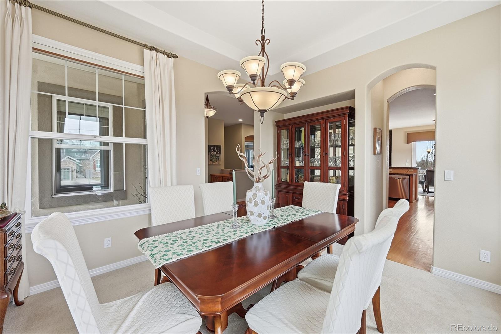 2626 Pemberly Avenue Highlands Ranch, CO 80126 - Photo 4 of 49 a view of a dining room with furniture wooden floor and chandelier