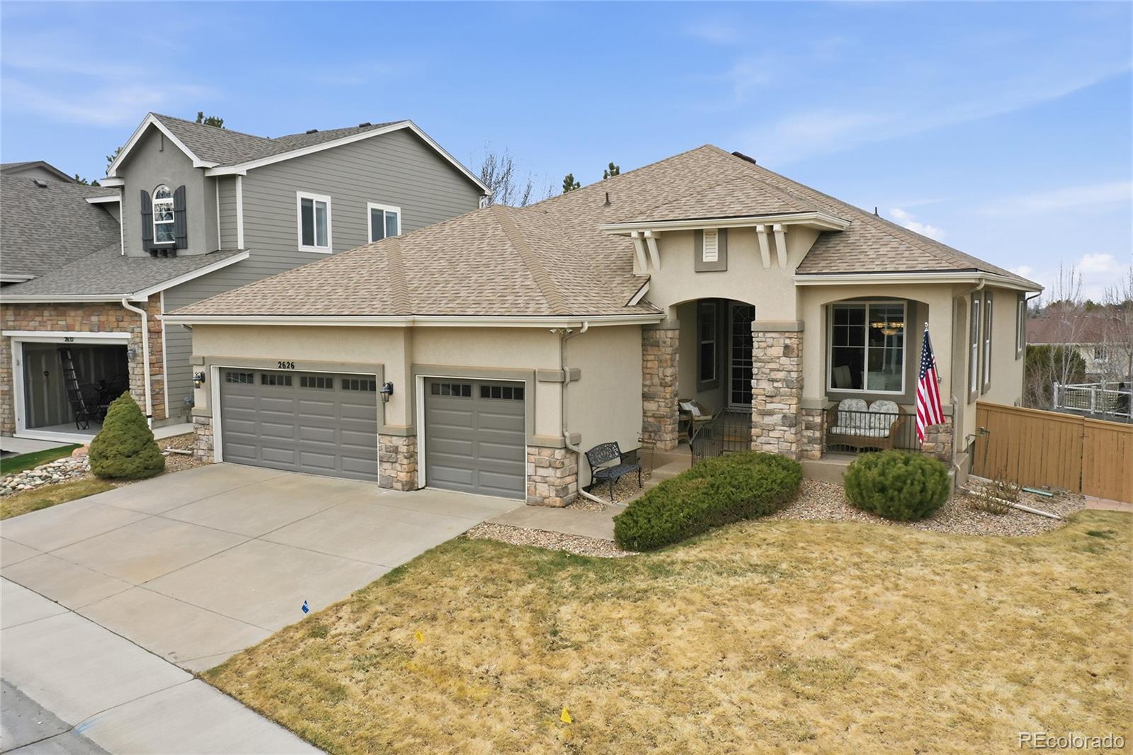 2626 Pemberly Avenue Highlands Ranch, CO 80126 - Photo 41 of 49 a front view of a house with garden