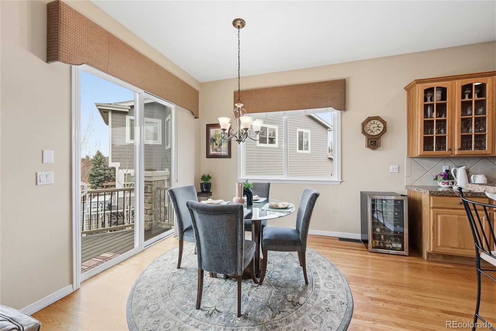2626 Pemberly Avenue Highlands Ranch, CO 80126 - Photo 10 of 49 a view of a dining room with furniture window and wooden floor
