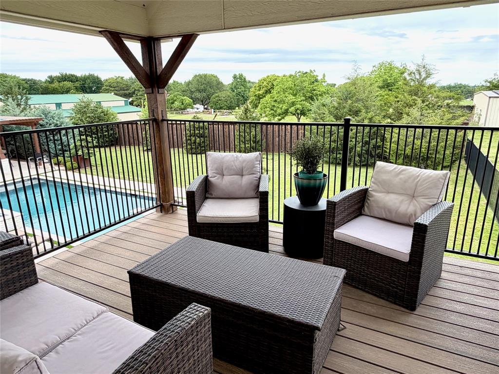 1304 Tinker Road Colleyville, TX 76034 - Photo 23 of 28 a view of a balcony with couch and wooden floor
