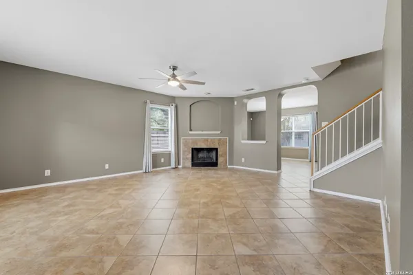 a view of an empty room with a fireplace and a window