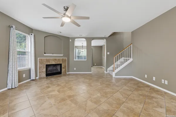 a view of empty room with fireplace and fan