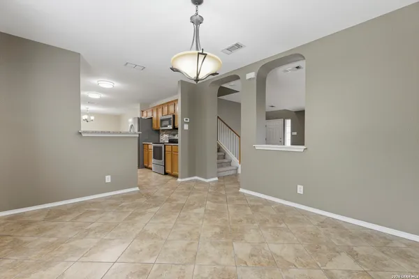 a view of a kitchen with a sink and refrigerator