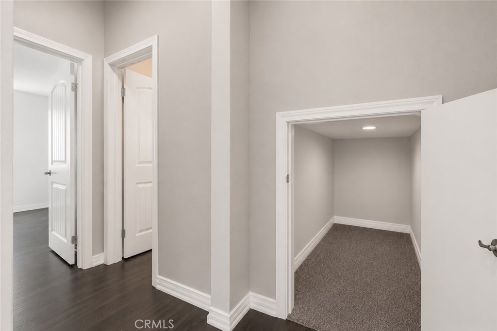 11056 Guffey Ranch Way Corona, CA 92883 - Photo 17 of 61 a view of a hallway with wooden floor