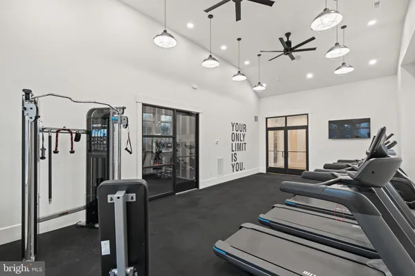 a spacious bedroom with a bed a ceiling fan and a rug