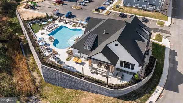 an aerial view of a residential houses with outdoor space