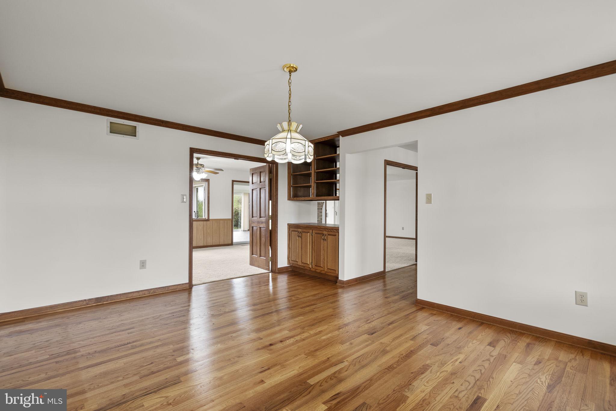 9224 Ball Road Ijamsville, MD 21754 - Photo 12 of 56 a view of a room with wooden floor ceiling fan and windows