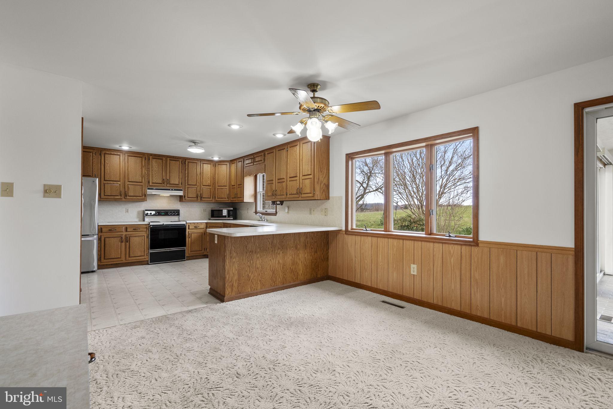 9224 Ball Road Ijamsville, MD 21754 - Photo 16 of 56 a kitchen with stainless steel appliances granite countertop a stove a sink a refrigerator and a cabinets