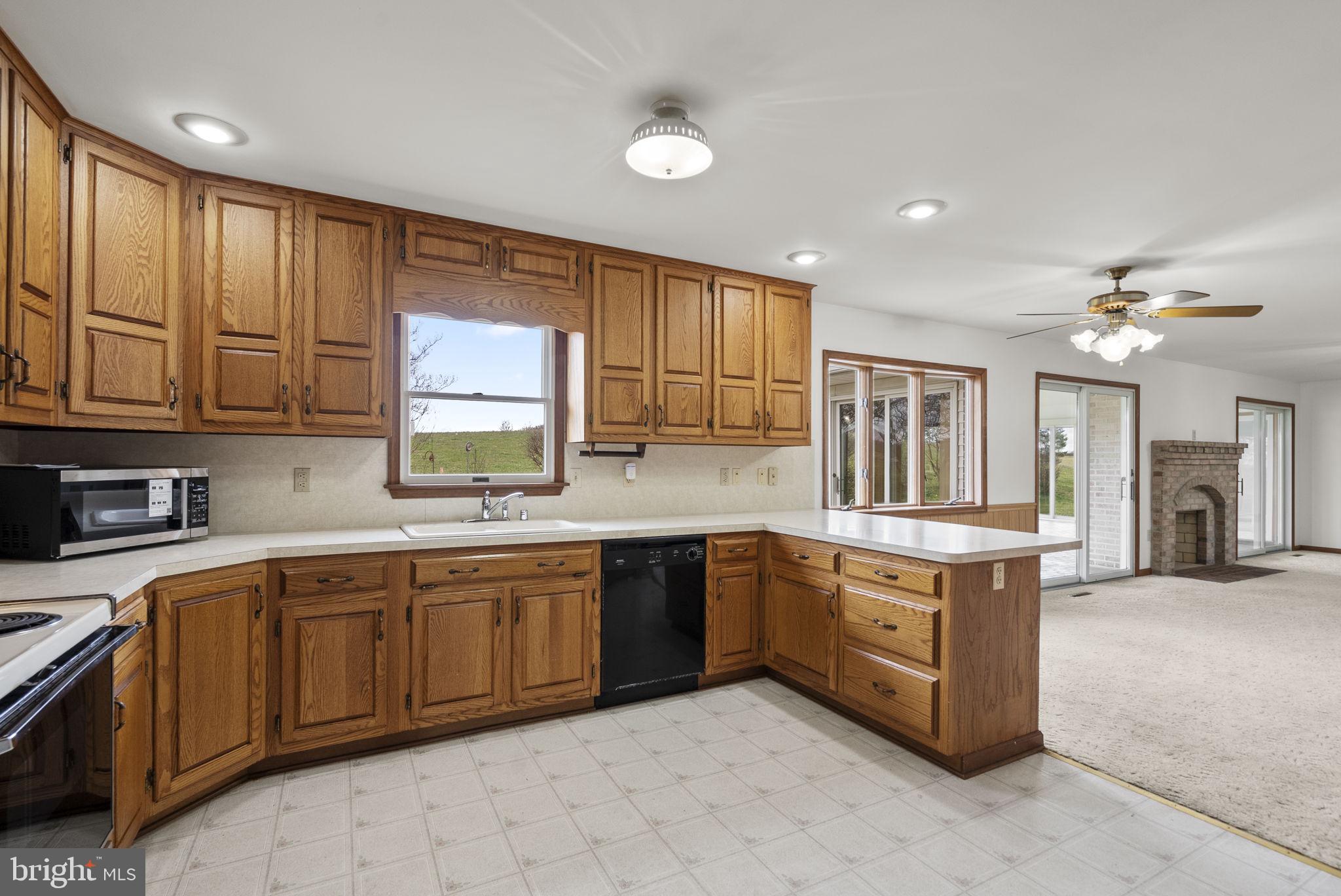 9224 Ball Road Ijamsville, MD 21754 - Photo 17 of 56 a large kitchen with stainless steel appliances granite countertop a stove sink and cabinets