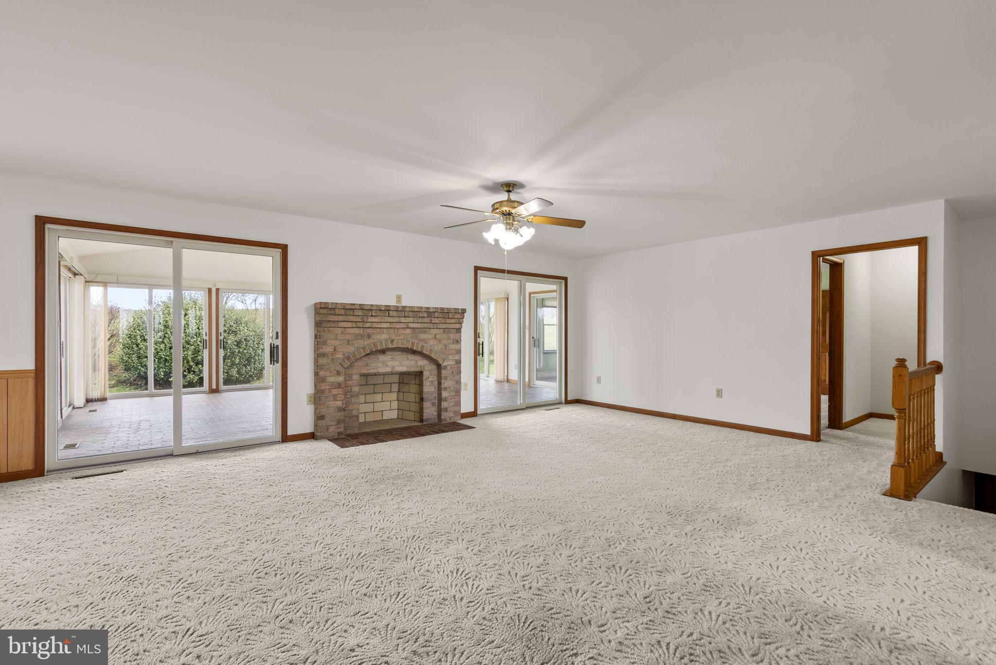 9224 Ball Road Ijamsville, MD 21754 - Photo 25 of 56 a view of a livingroom with a fireplace and large windows