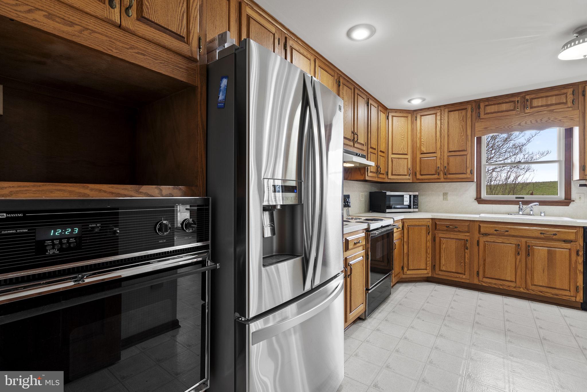 9224 Ball Road Ijamsville, MD 21754 - Photo 28 of 56 a kitchen with stainless steel appliances a refrigerator sink and cabinets