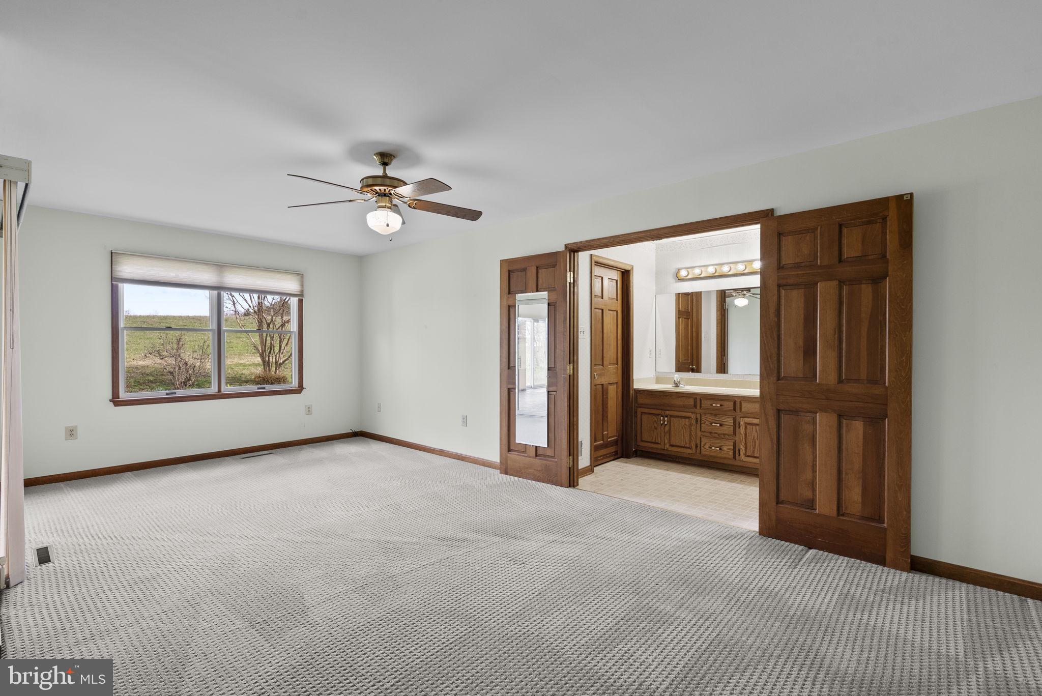 9224 Ball Road Ijamsville, MD 21754 - Photo 36 of 56 an empty room with windows and ceiling fan