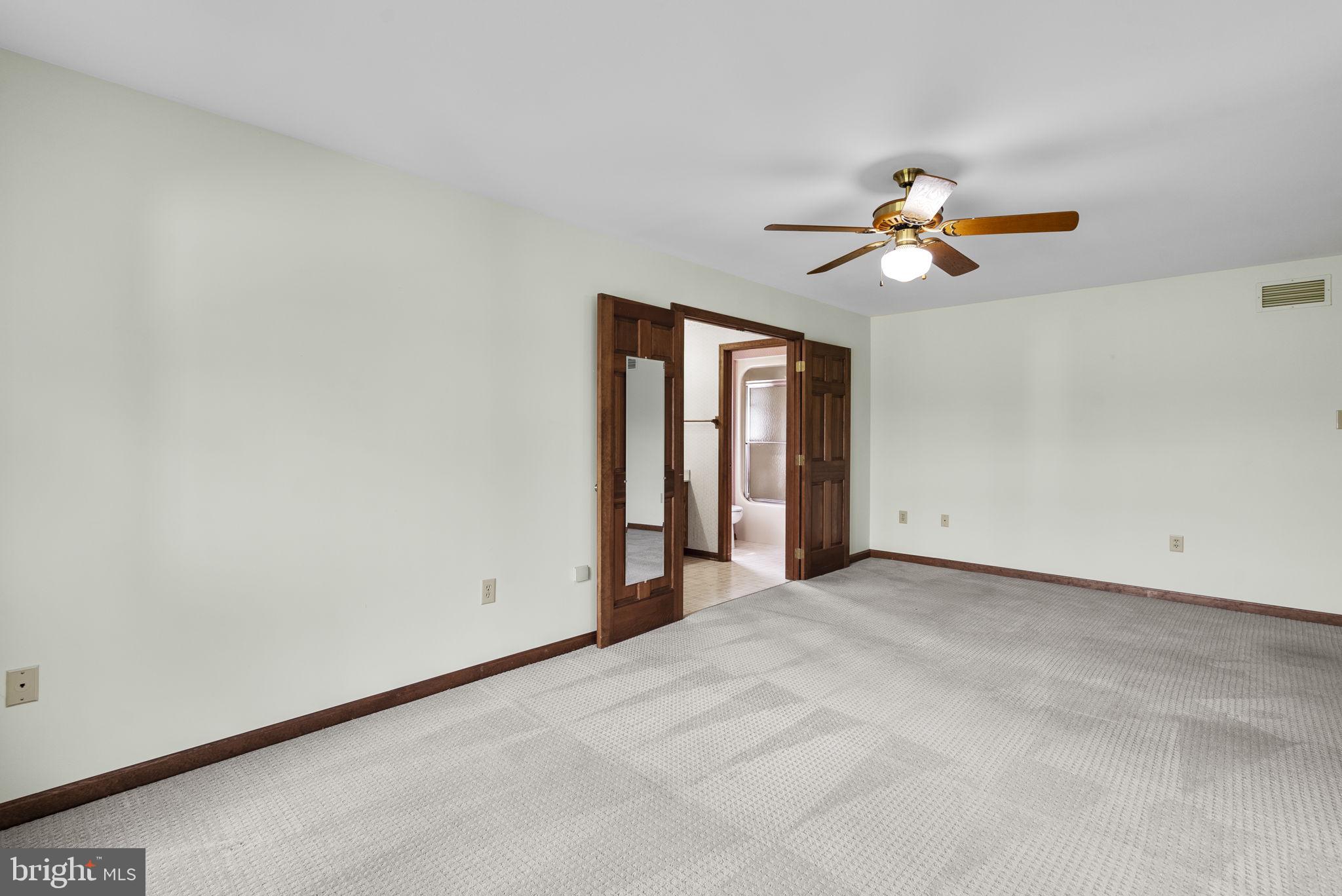 9224 Ball Road Ijamsville, MD 21754 - Photo 37 of 56 an empty room with windows and chandelier fan