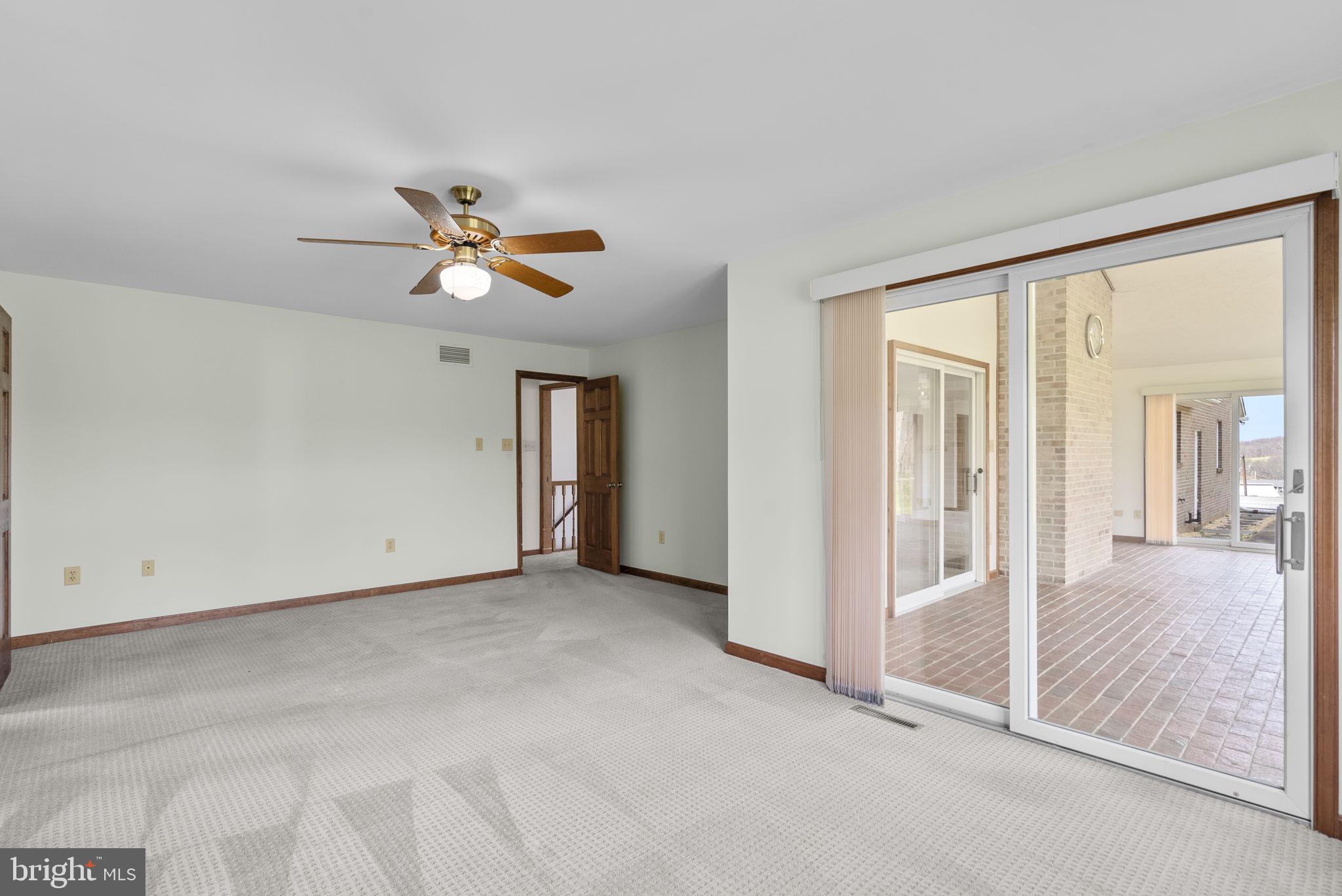 9224 Ball Road Ijamsville, MD 21754 - Photo 38 of 56 an empty room with a ceiling fan and window