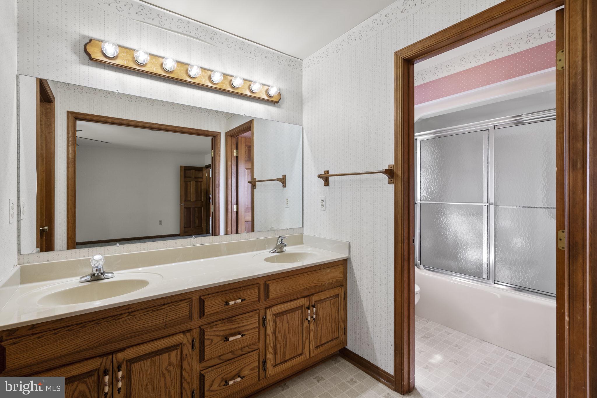 9224 Ball Road Ijamsville, MD 21754 - Photo 39 of 56 a bathroom with a double vanity sink and a mirror