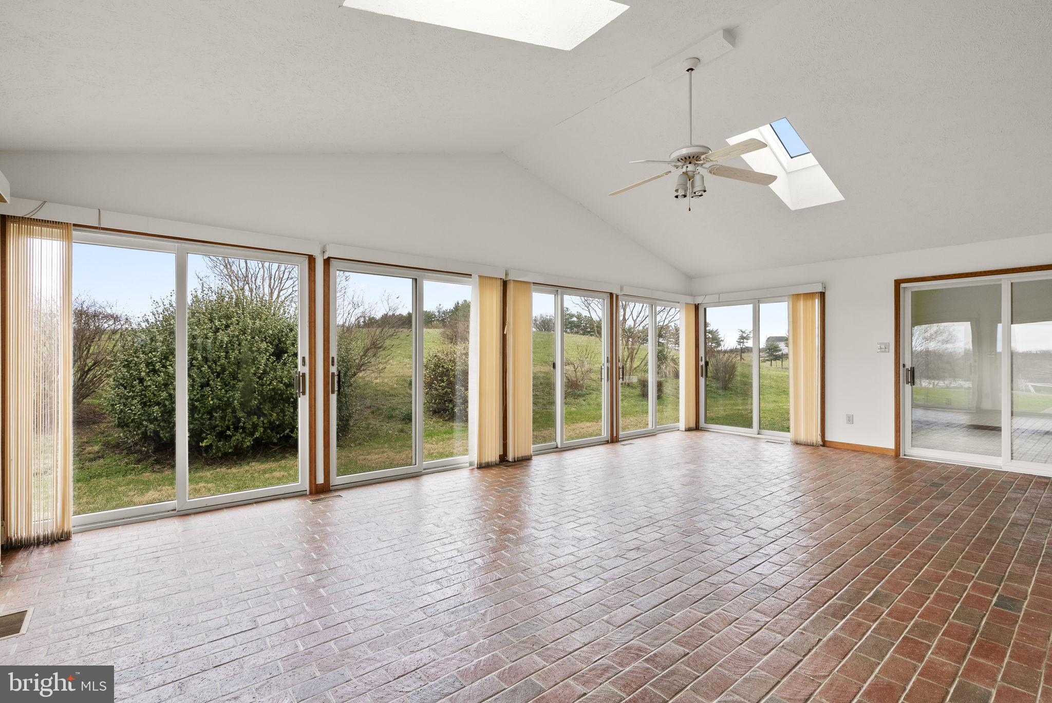9224 Ball Road Ijamsville, MD 21754 - Photo 43 of 56 a view of an empty room with wooden floor and a window