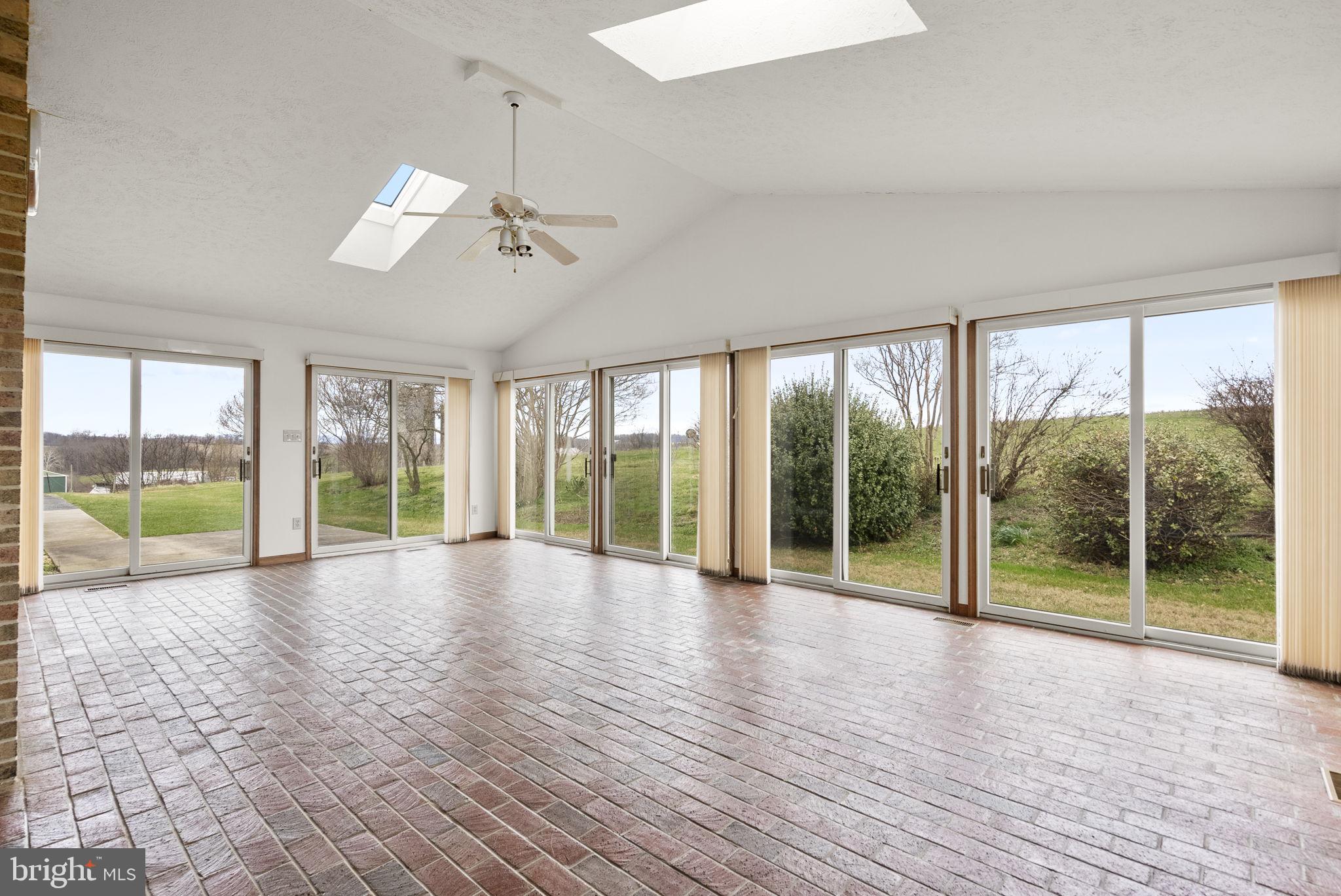 9224 Ball Road Ijamsville, MD 21754 - Photo 7 of 56 a view of an empty room with wooden floor and a window