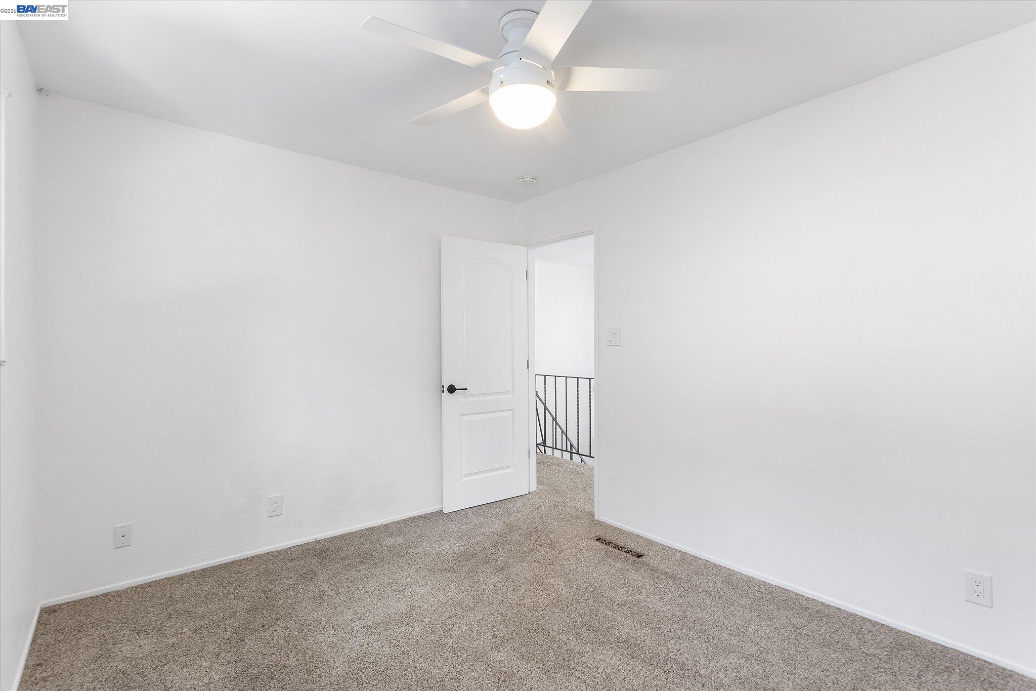 16683 Kildare Road Castro Valley, CA 94546 - Photo 44 of 77 an empty room with a ceiling fan and a fan